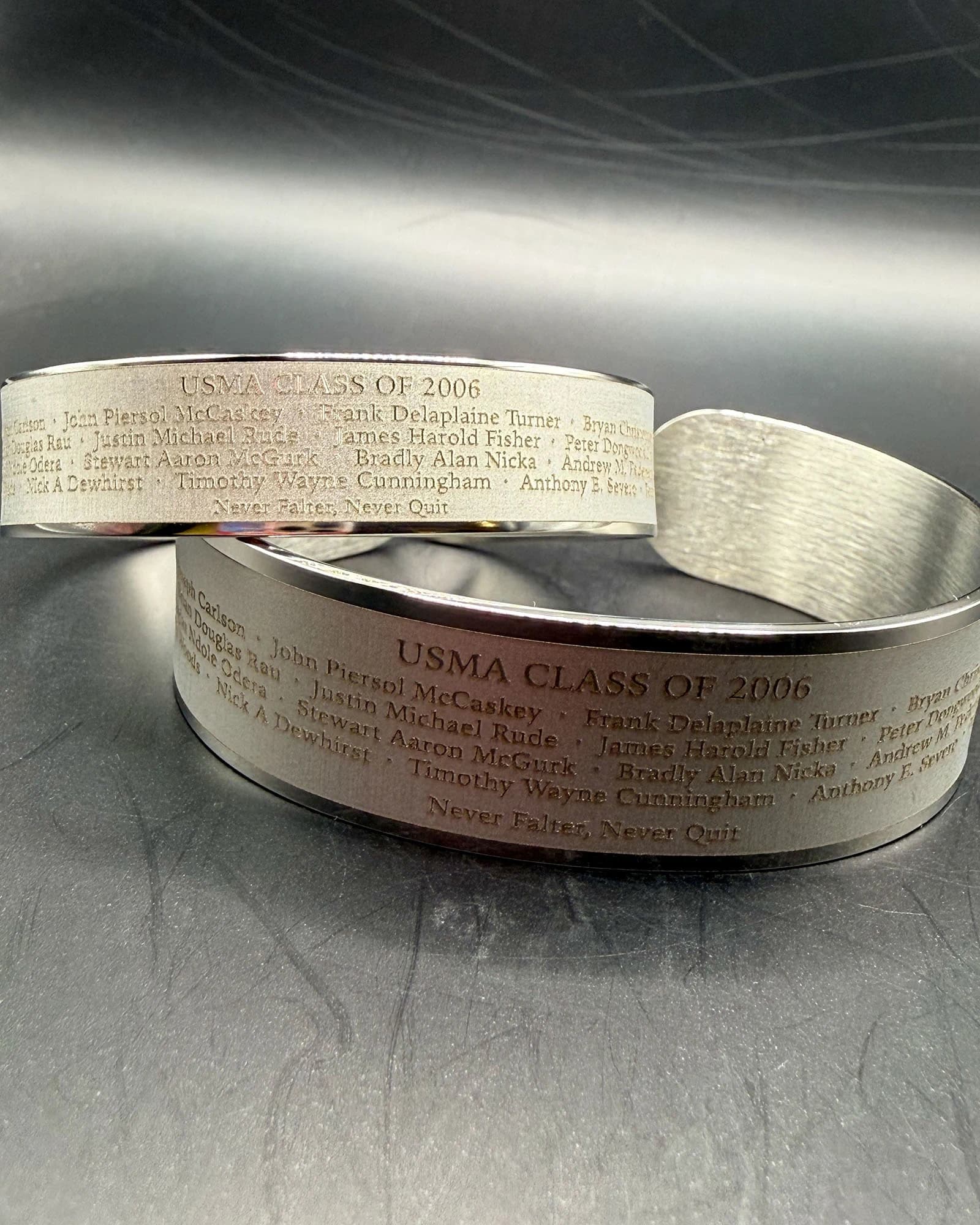 Two finished USMA Class of 2006 memorial bracelets showing the approved 17-name roster engraving.